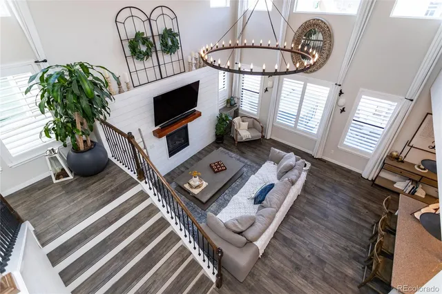 a living room with furniture a flat screen tv and a potted plant