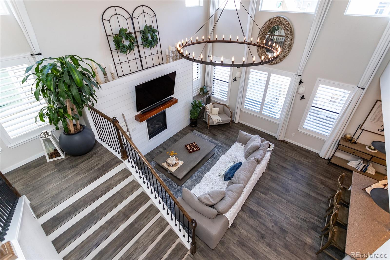 4208 Notch Trail Colorado Springs, CO 80924 - Photo 10 of 40 a living room with furniture a chandelier a rug and a window