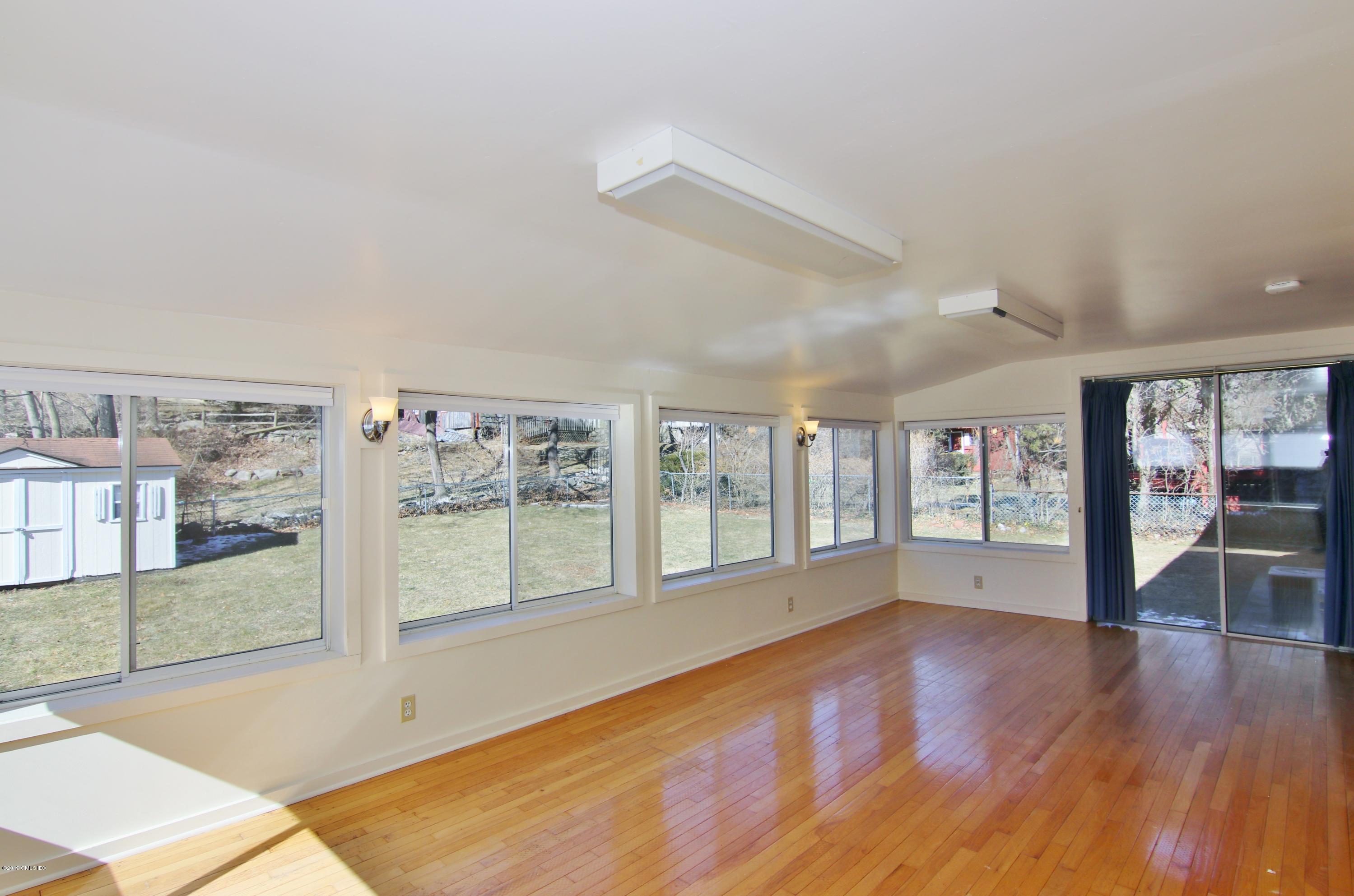 Undisclosed Address Riverside, CT 06878 - Photo 11 of 28 a view of an empty room with wooden floor and a window