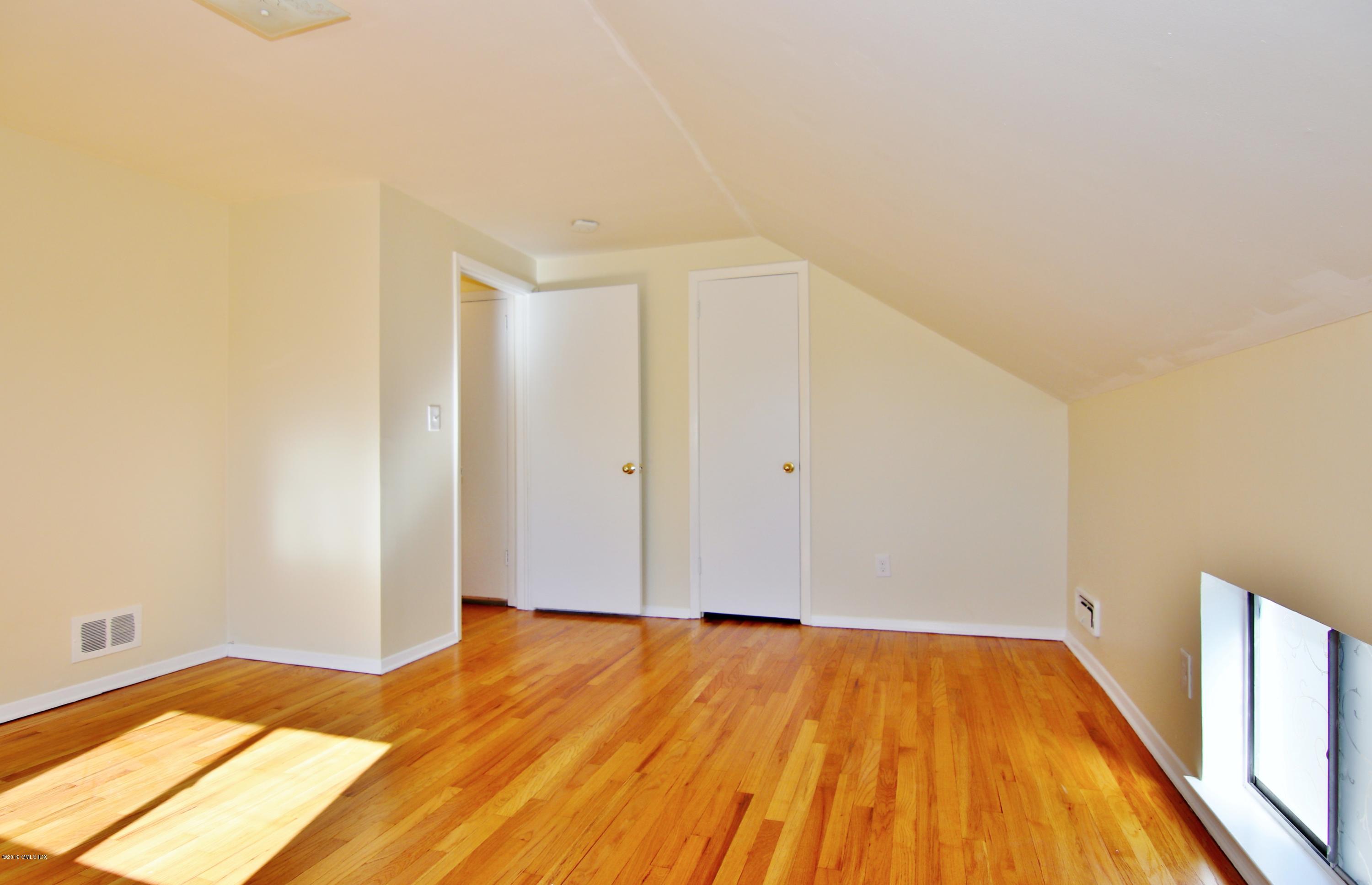 Undisclosed Address Riverside, CT 06878 - Photo 16 of 28 a view of a room with wooden floor and white walls