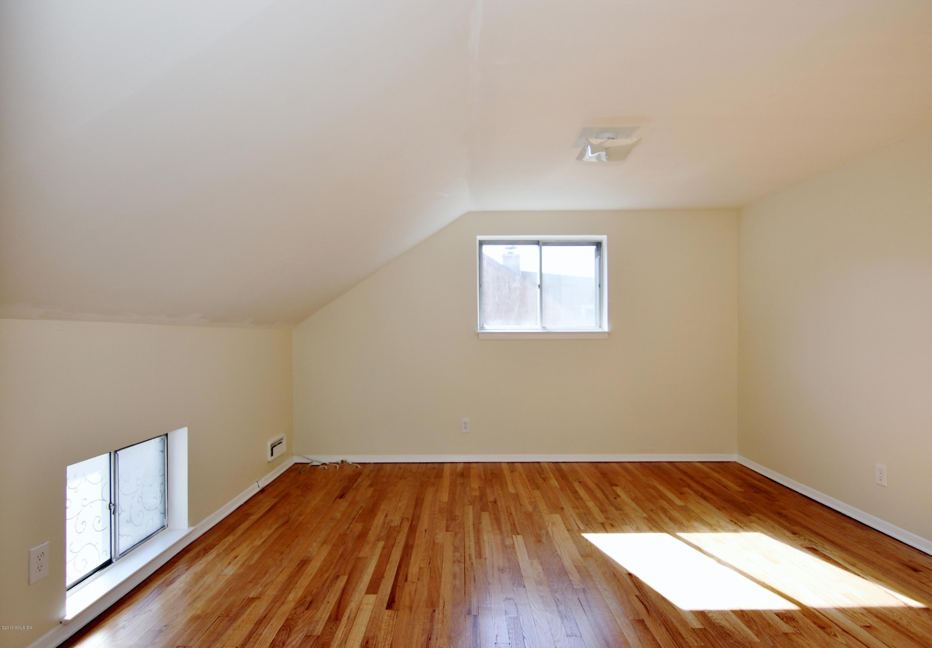 Undisclosed Address Riverside, CT 06878 - Photo 17 of 28 a view of a room with wooden floor and window