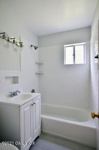 Undisclosed Address Riverside, CT 06878 - Photo 19 of 28 a bathroom with a sink a bathtub and a shower