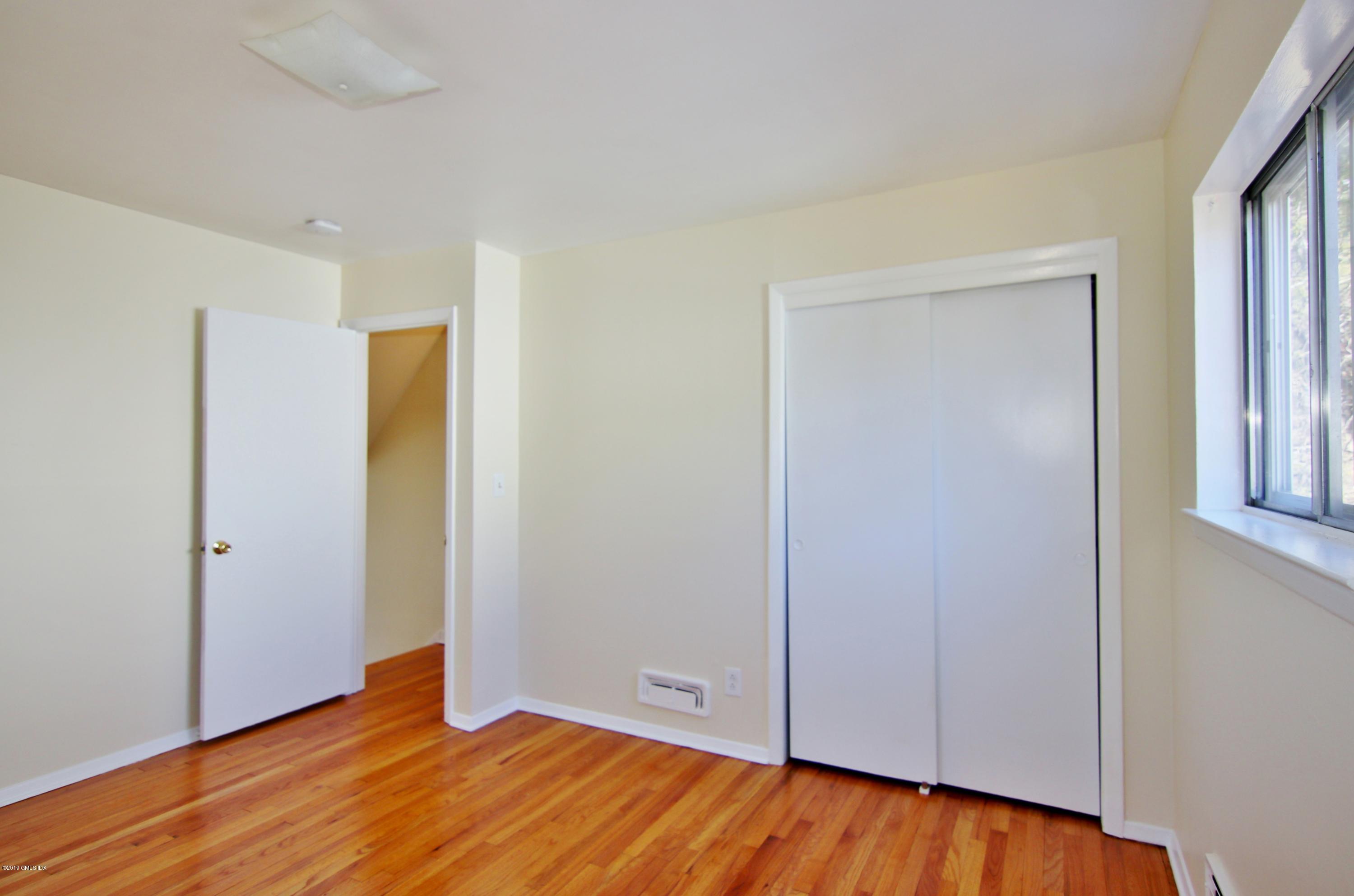 Undisclosed Address Riverside, CT 06878 - Photo 21 of 28 an empty room with wooden floor and closet