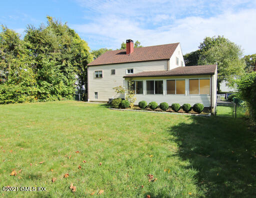 Undisclosed Address Riverside, CT 06878 - Photo 23 of 28 a front view of a house with garden