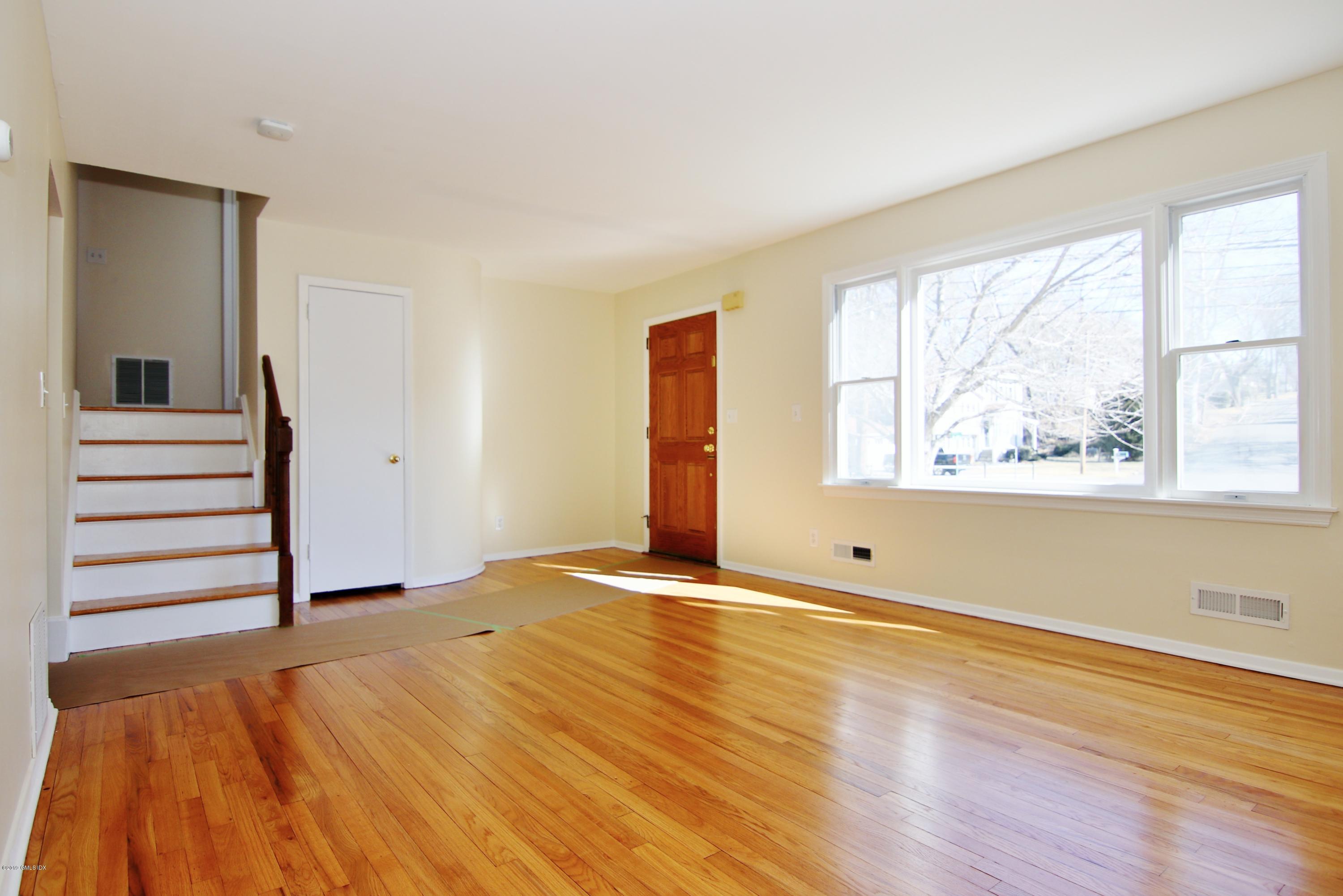 Undisclosed Address Riverside, CT 06878 - Photo 3 of 28 a view of an empty room with wooden floor and a window