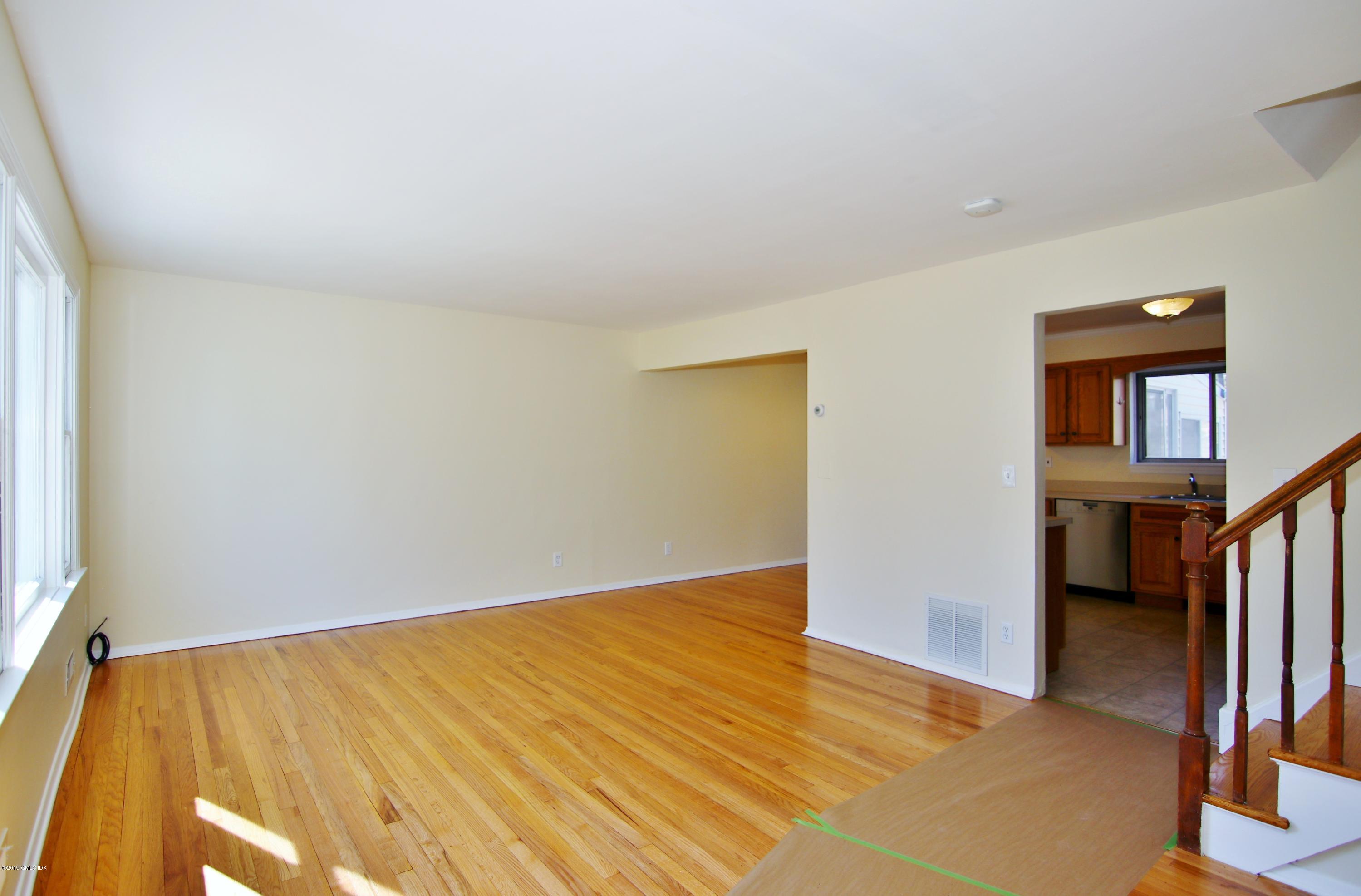 Undisclosed Address Riverside, CT 06878 - Photo 4 of 28 an empty room with wooden floor and a window