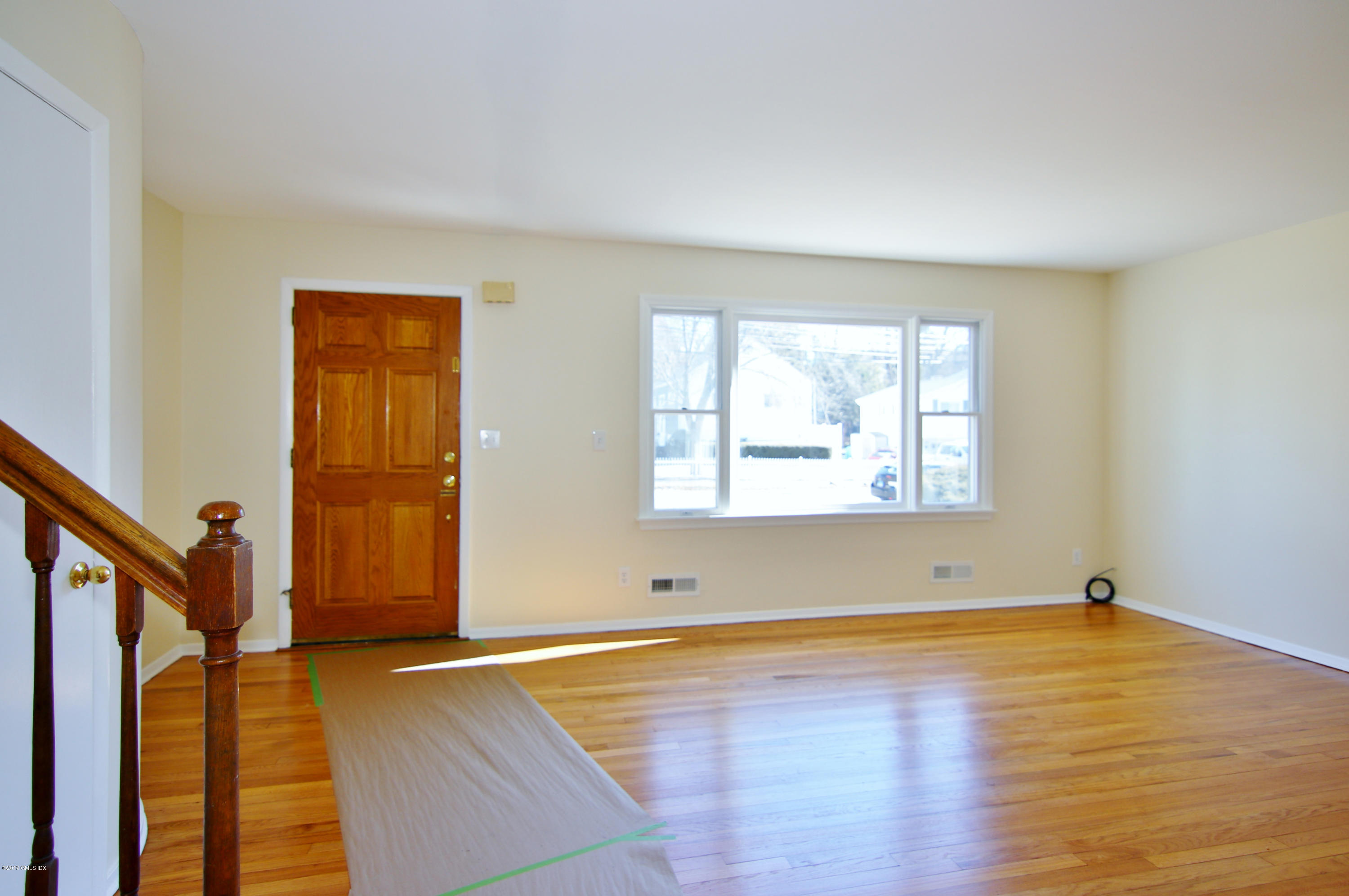 Undisclosed Address Riverside, CT 06878 - Photo 6 of 28 a view of an empty room with wooden floor and a window