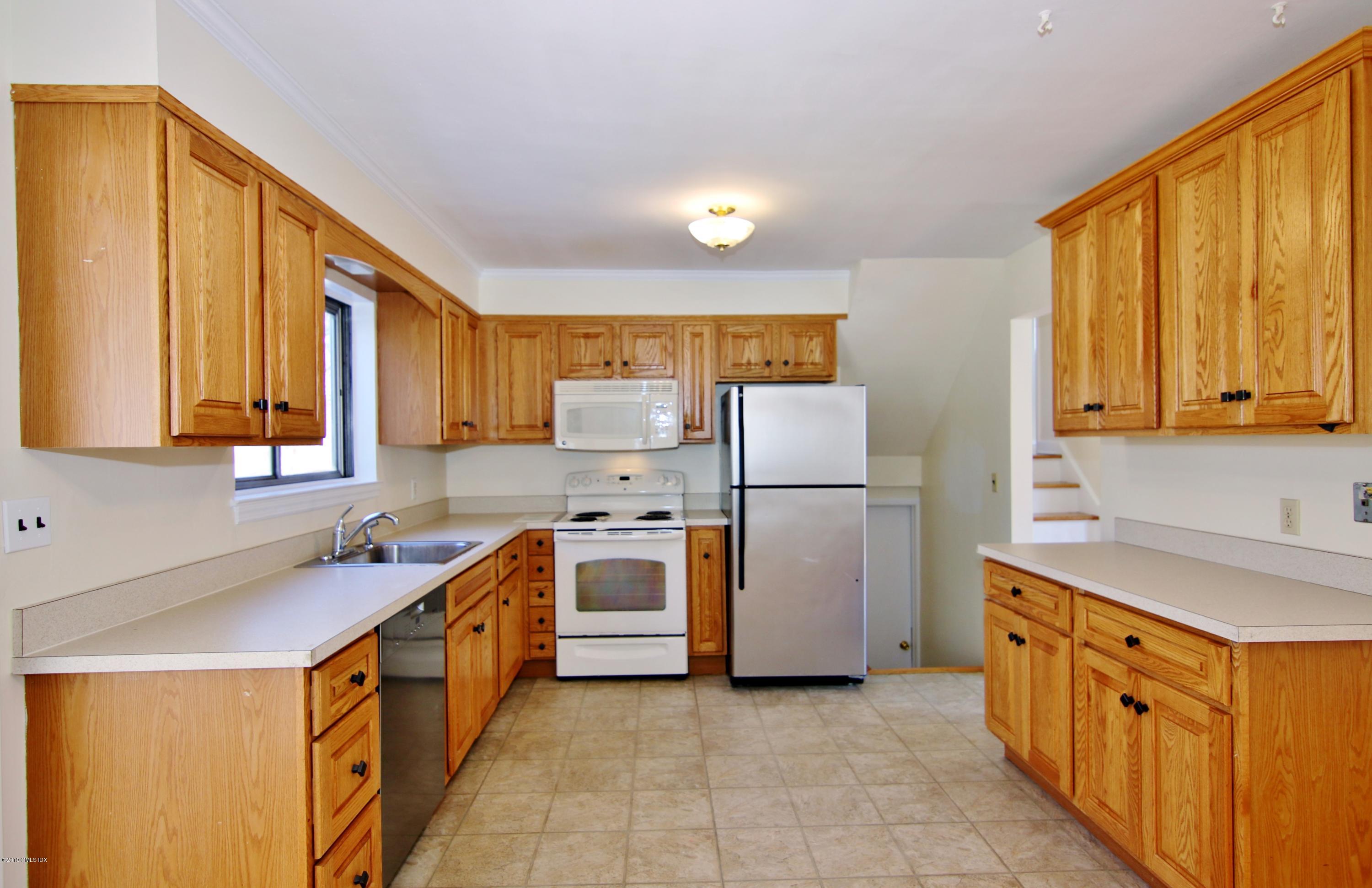Undisclosed Address Riverside, CT 06878 - Photo 8 of 28 a kitchen with stainless steel appliances granite countertop a sink stove and refrigerator