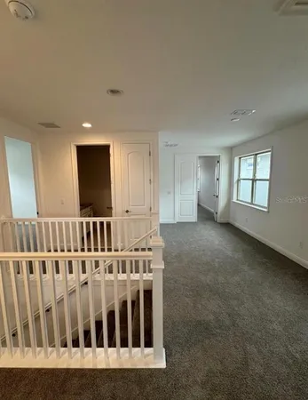 a view of hallway with windows