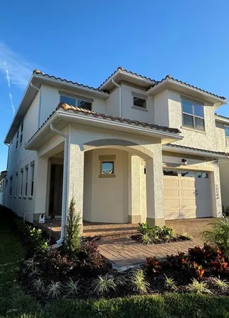 a view of a house with a small yard