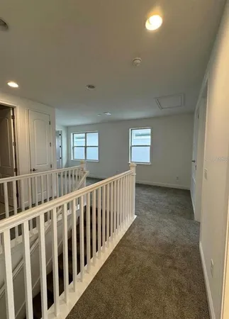 a view of a hallway with entryway to window