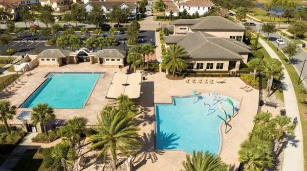 a front view of a house with garden and sitting area