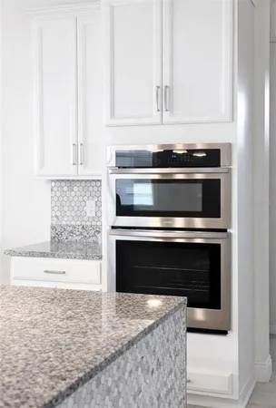 a large kitchen with kitchen island a sink stainless steel appliances and cabinets