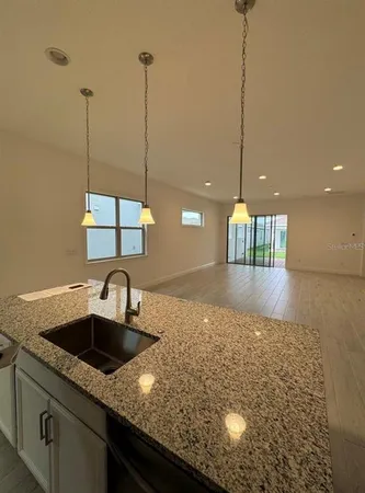 a kitchen with kitchen island a sink a counter space and appliances