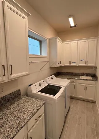 a kitchen that has a sink and a stove in it