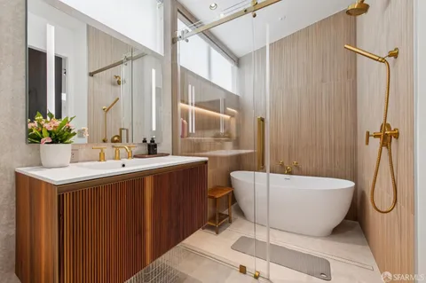a bathroom with a sink mirror toilet and shower