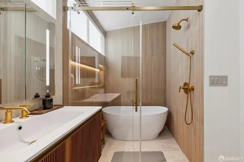 a bathroom with a tub sink and mirror