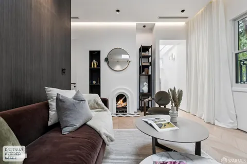 a living room with furniture and a mirror