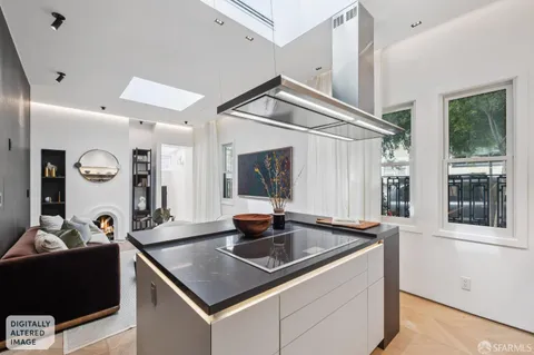 a kitchen that has a sink and a stove with wooden floor