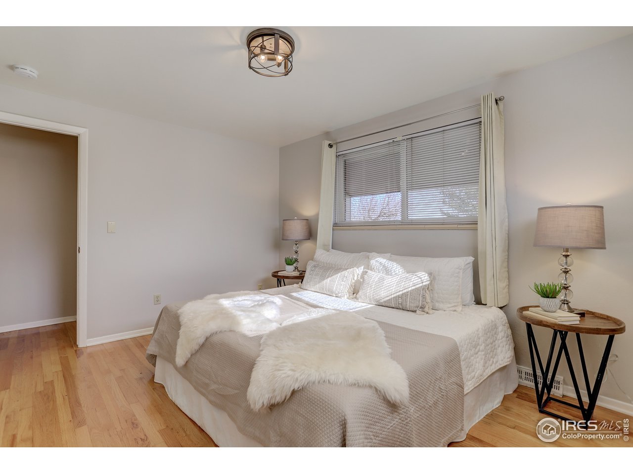 385 Manhattan Drive Boulder, CO 80303 - Photo 14 of 28 a bedroom with a bed and a table