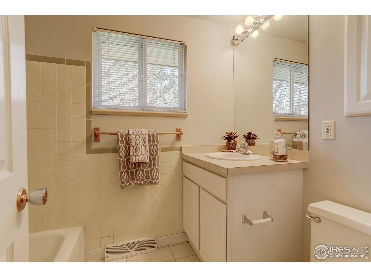 385 Manhattan Drive Boulder, CO 80303 - Photo 15 of 28 a bathroom with a sink a mirror and a vanity