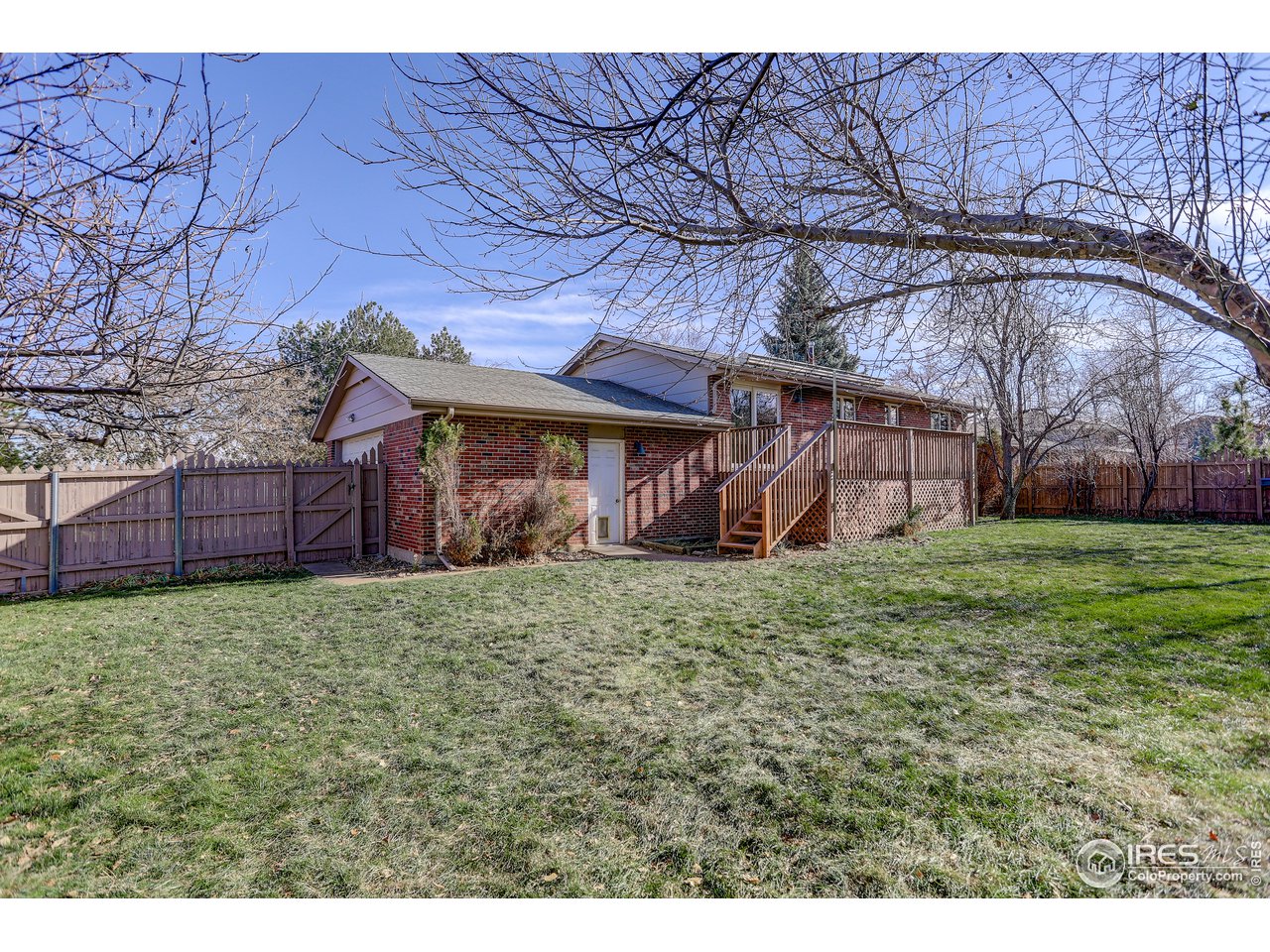 385 Manhattan Drive Boulder, CO 80303 - Photo 25 of 28 a backyard of a house with wooden fence