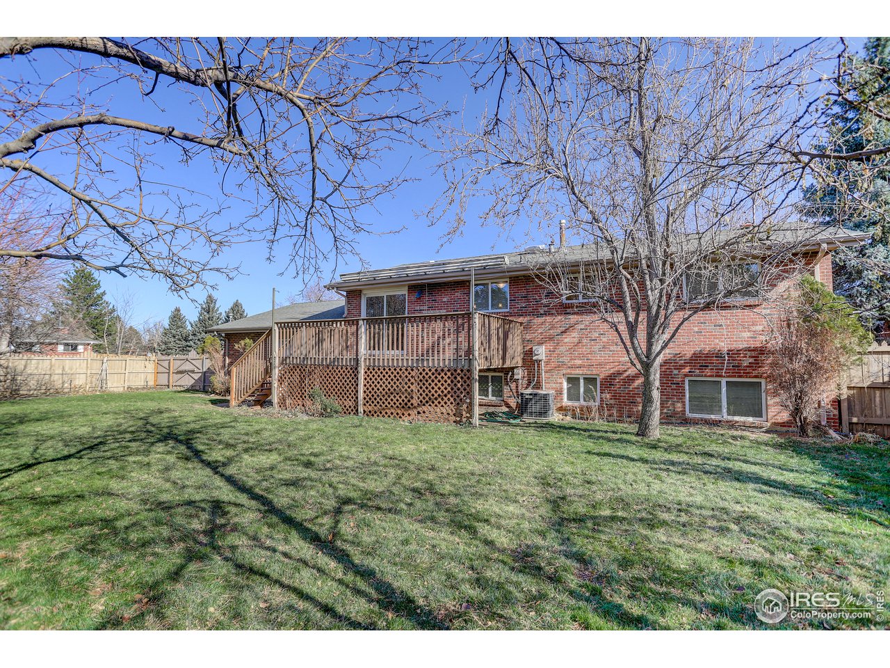 385 Manhattan Drive Boulder, CO 80303 - Photo 27 of 28 a view of a house with a big yard and large trees