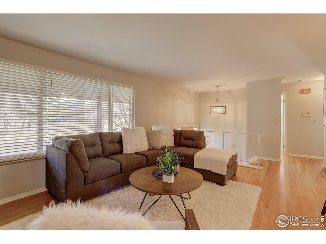 385 Manhattan Drive Boulder, CO 80303 - Photo 5 of 28 a living room with furniture a large window and a wooden floor