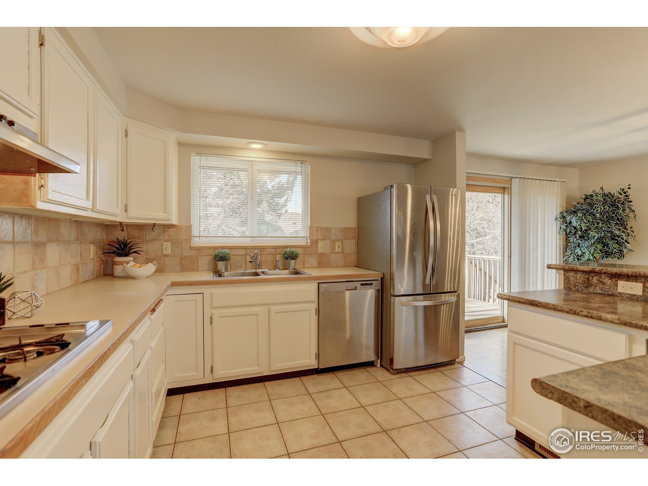 385 Manhattan Drive Boulder, CO 80303 - Photo 10 of 28 a kitchen with a sink a refrigerator and cabinets