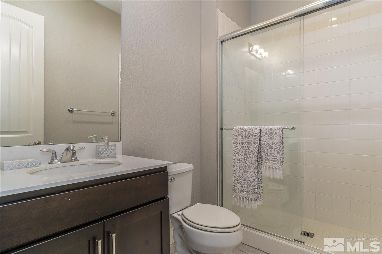 9272 Red Spring Drive Reno, NV 89521 - Photo 19 of 25 a bathroom with a sink a toilet a shower and a mirror