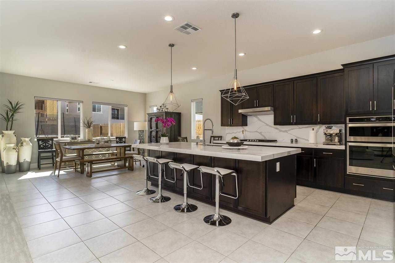 9272 Red Spring Drive Reno, NV 89521 - Photo 3 of 25 a kitchen with kitchen island granite countertop a sink counter top space appliances and cabinets