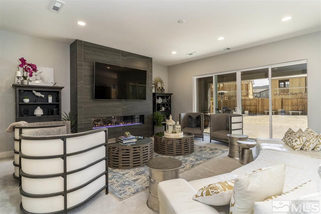 9272 Red Spring Drive Reno, NV 89521 - Photo 4 of 25 a living room with furniture a flat screen tv and a floor to ceiling window
