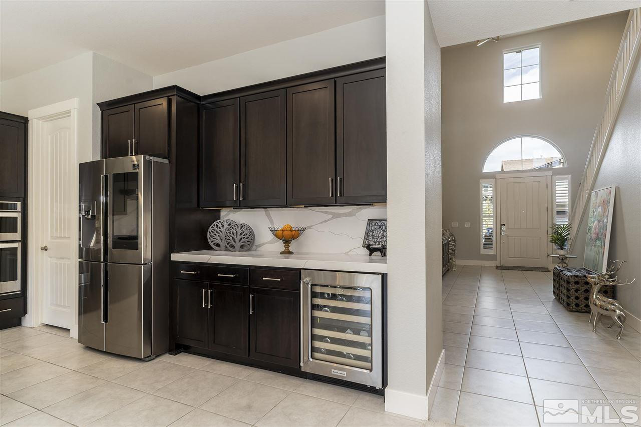 9272 Red Spring Drive Reno, NV 89521 - Photo 9 of 25 a kitchen with stainless steel appliances granite countertop a refrigerator and a sink