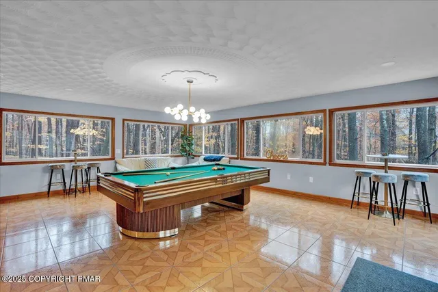 a backyard of a house with wooden deck and furniture