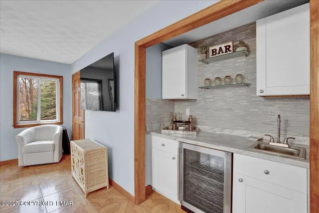 an aerial view of a house with yard swimming pool and outdoor seating