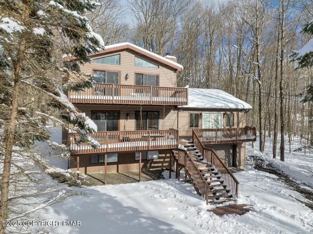 a kitchen with stainless steel appliances granite countertop a refrigerator a stove and a sink with cabinets