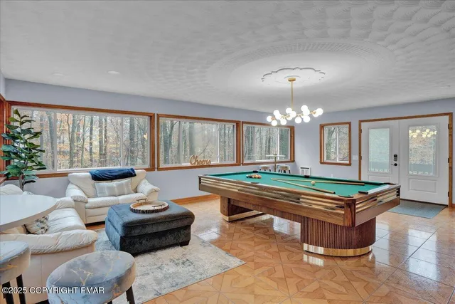 a view of a patio with table and chairs potted plants and a large tree