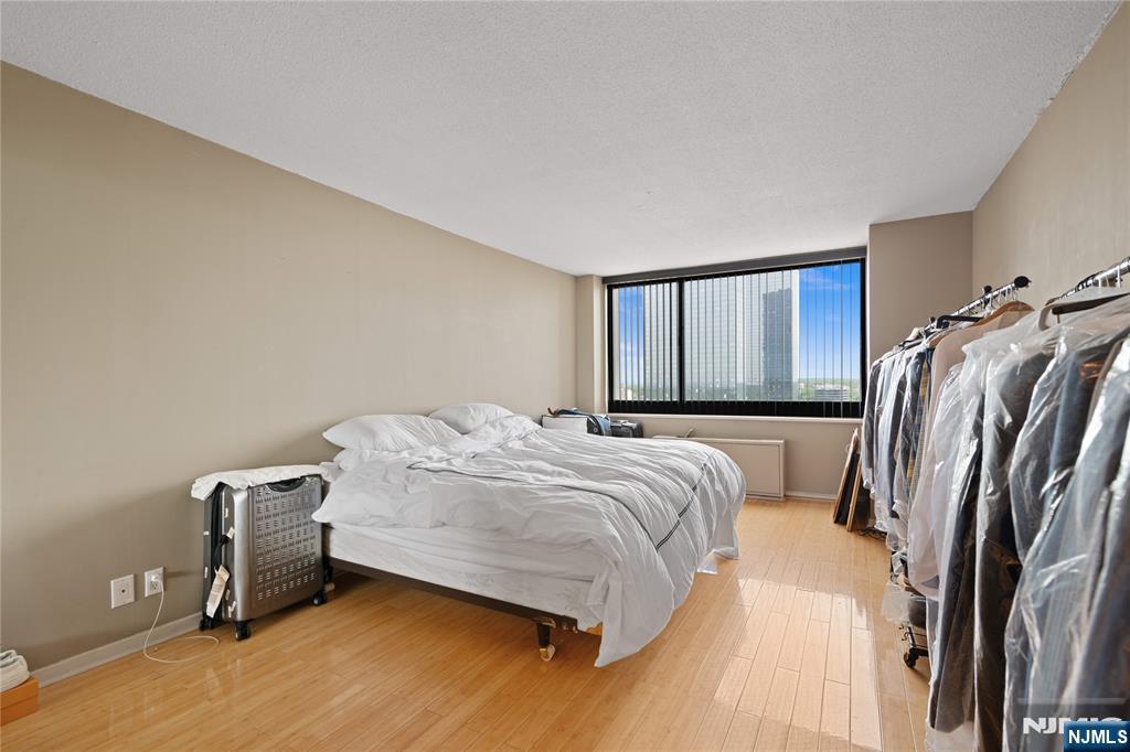 200 Old Palisade Road, Unit 21J Fort Lee, NJ 07024 - Photo 14 of 29 a bedroom with a bed and a window