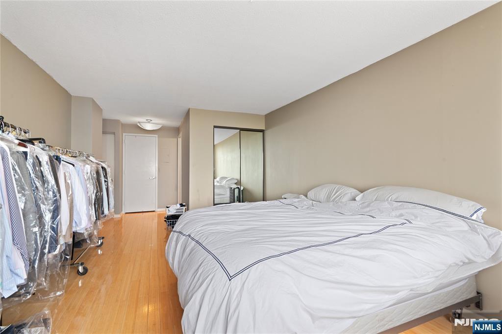 200 Old Palisade Road, Unit 21J Fort Lee, NJ 07024 - Photo 16 of 29 a bed sitting in a bedroom next to a bathroom