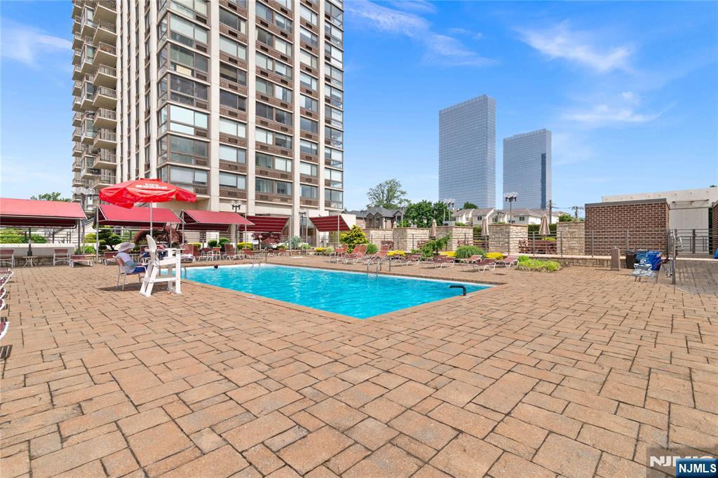 200 Old Palisade Road, Unit 21J Fort Lee, NJ 07024 - Photo 22 of 29 a view of an buildings with swimming pool and sitting area