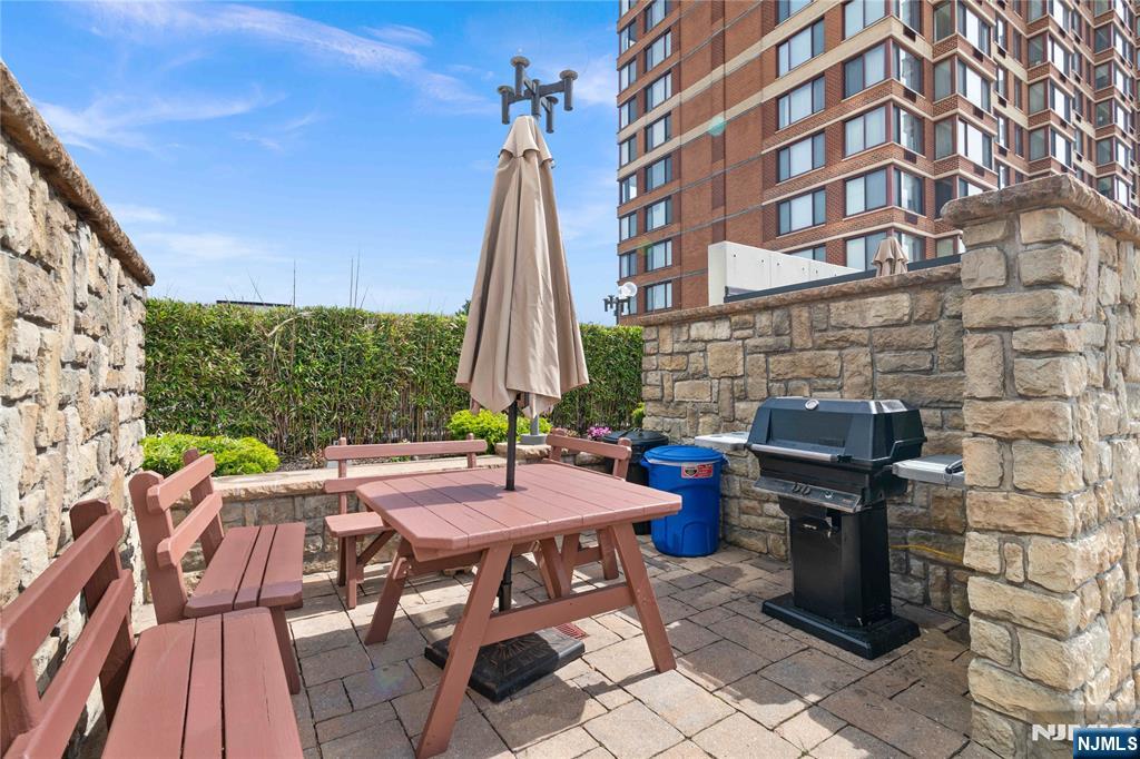 200 Old Palisade Road, Unit 21J Fort Lee, NJ 07024 - Photo 25 of 29 a table and chairs sitting in front of a building
