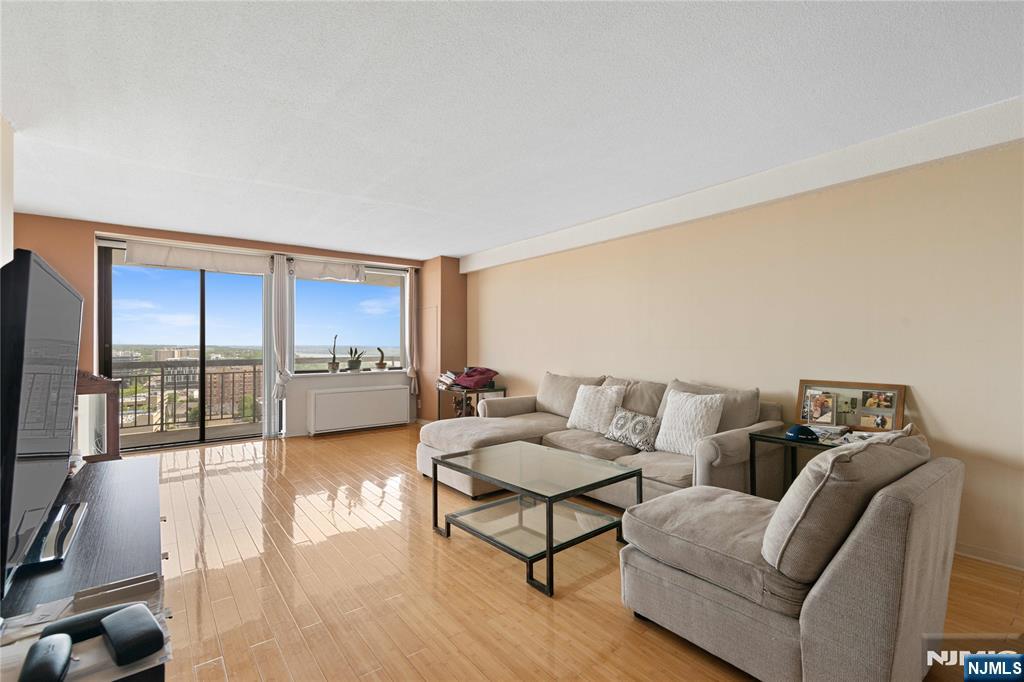 200 Old Palisade Road, Unit 21J Fort Lee, NJ 07024 - Photo 7 of 29 a living room with furniture and a large window
