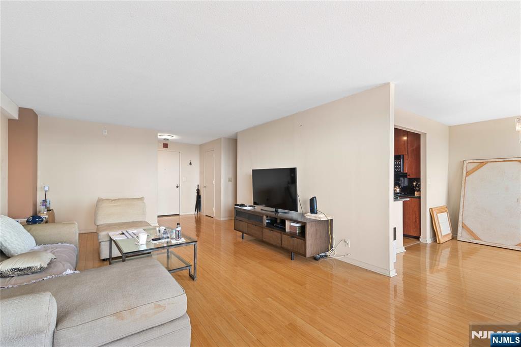 200 Old Palisade Road, Unit 21J Fort Lee, NJ 07024 - Photo 8 of 29 a living room with furniture and a flat screen tv