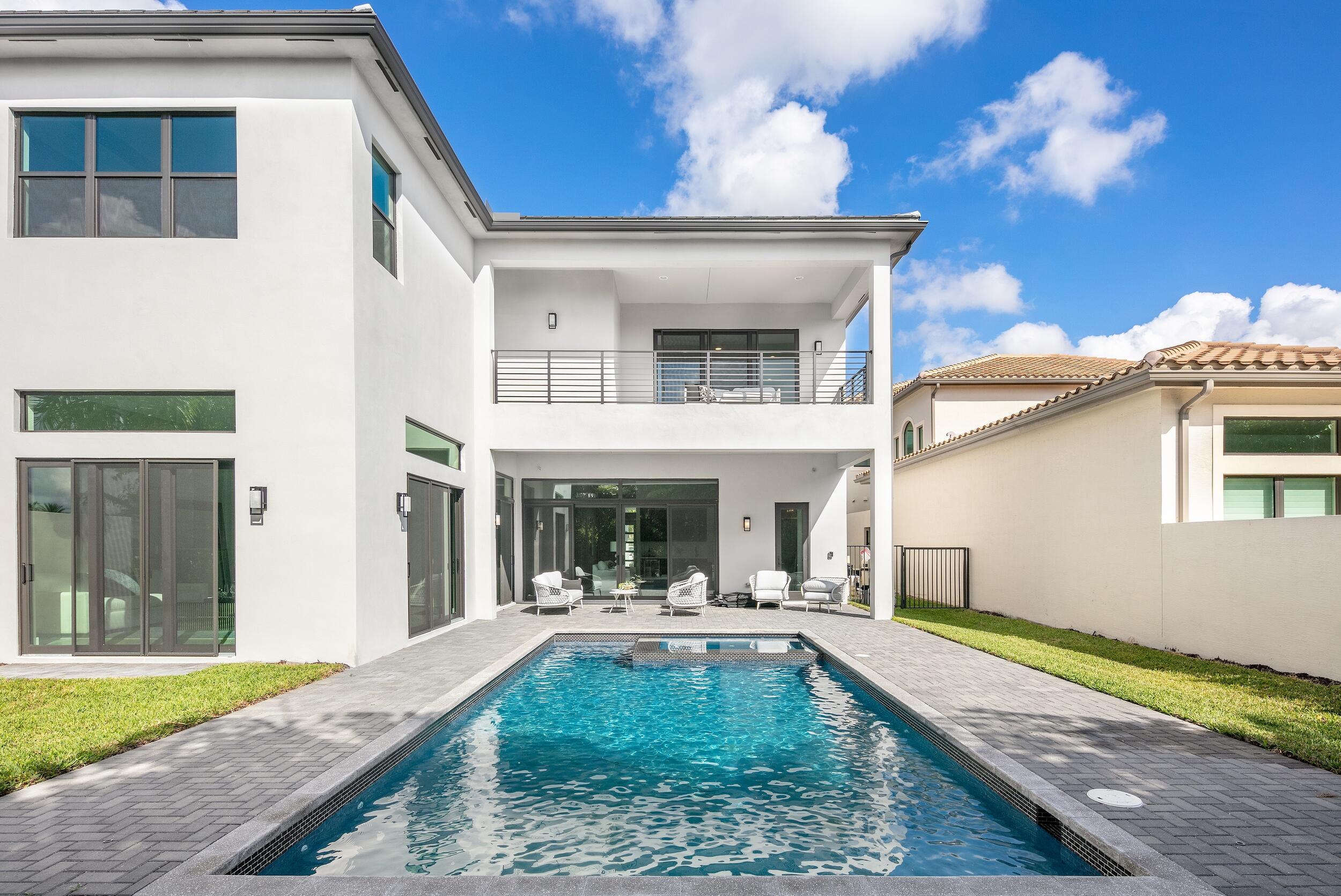 9132 Benedetta Place Boca Raton, FL 33496 - Photo 24 of 50 a view of a house with swimming pool and porch