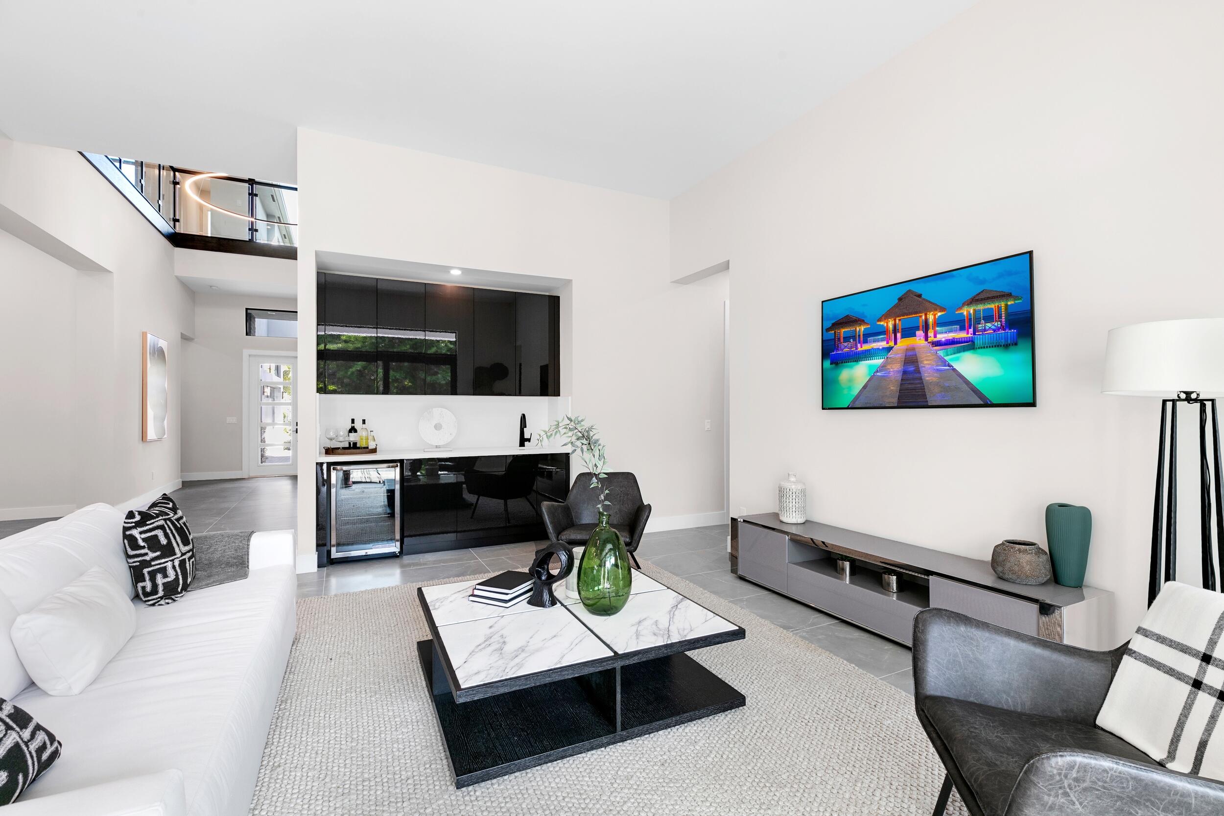 9132 Benedetta Place Boca Raton, FL 33496 - Photo 25 of 50 a living room with furniture a rug and a flat screen tv