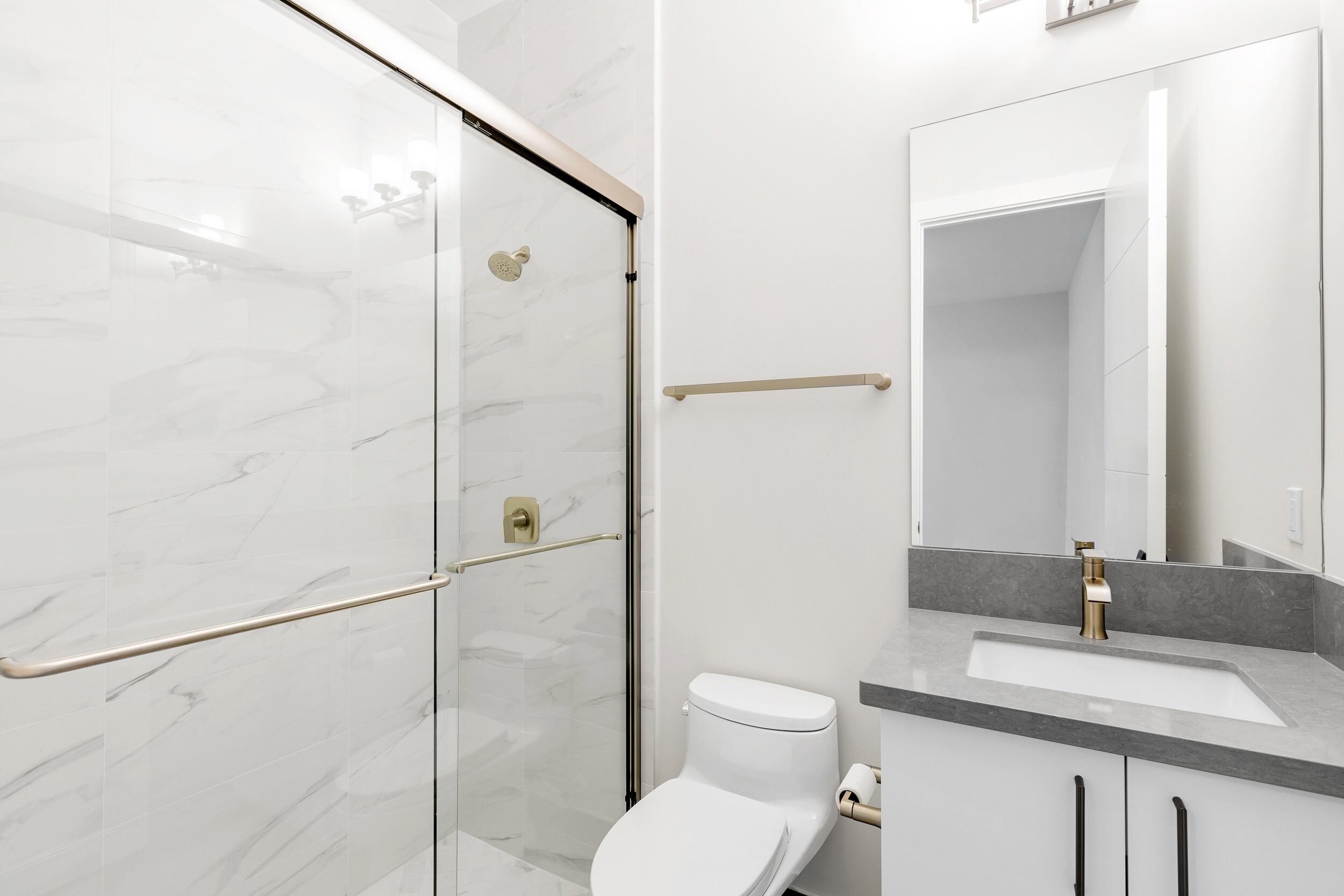 9132 Benedetta Place Boca Raton, FL 33496 - Photo 28 of 50 a bathroom with a granite countertop sink toilet and shower