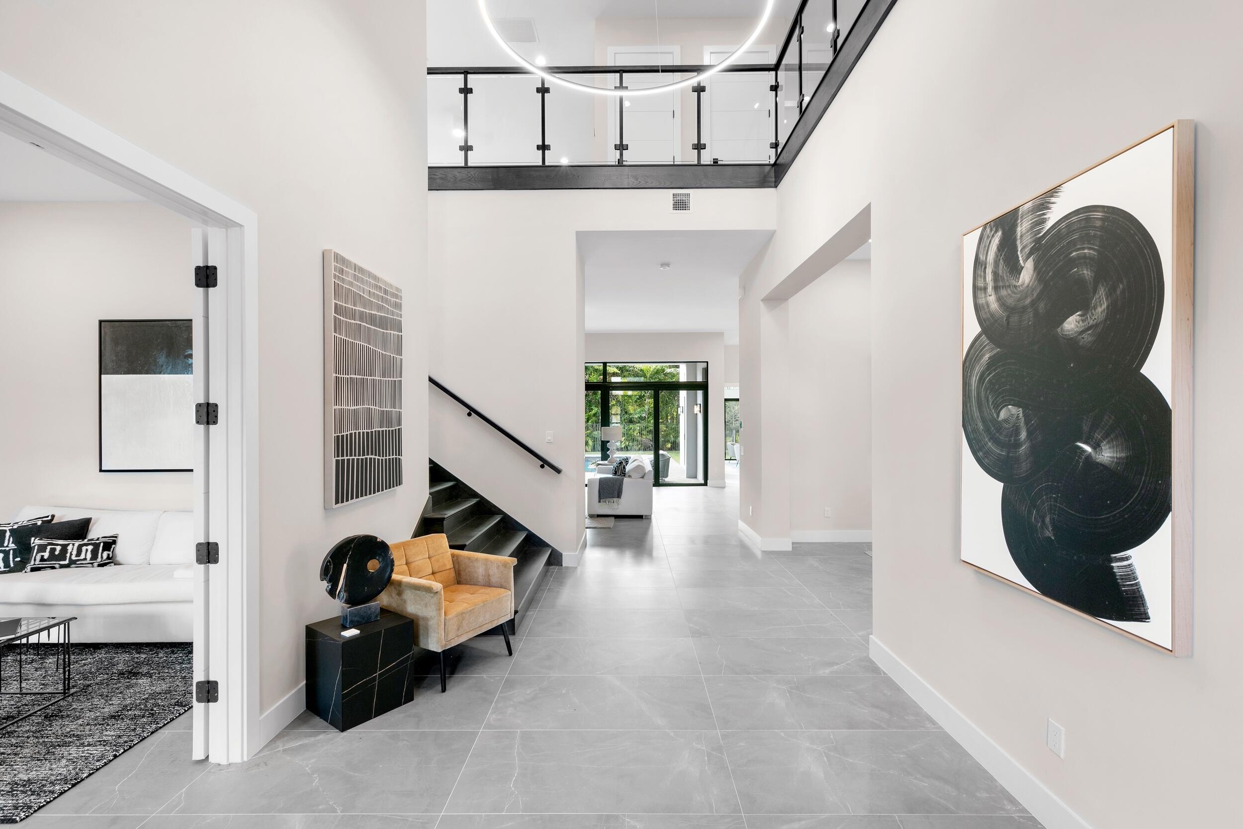 9132 Benedetta Place Boca Raton, FL 33496 - Photo 3 of 50 a living room with furniture and a chandelier