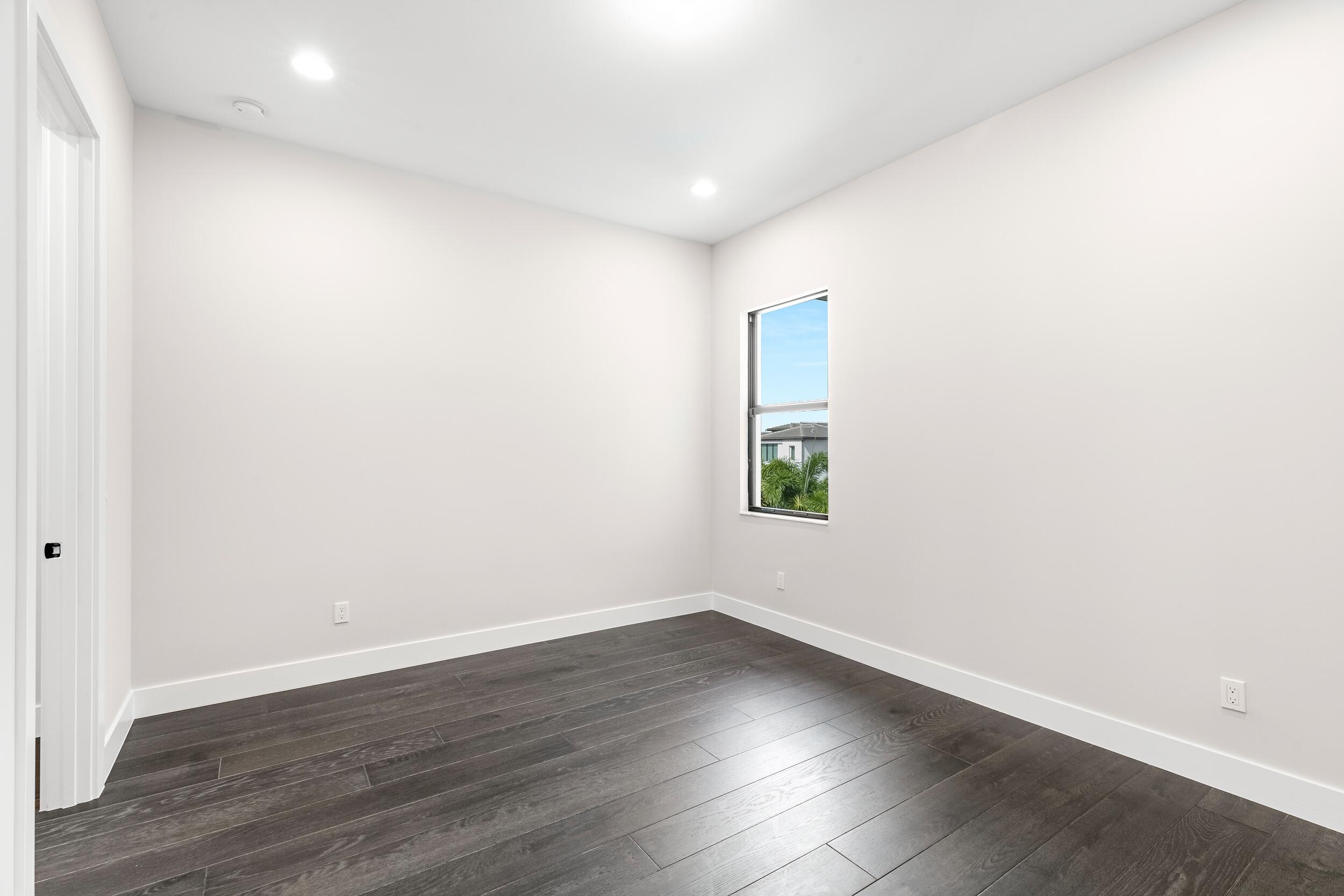 9132 Benedetta Place Boca Raton, FL 33496 - Photo 41 of 50 an empty room with wooden floor and window