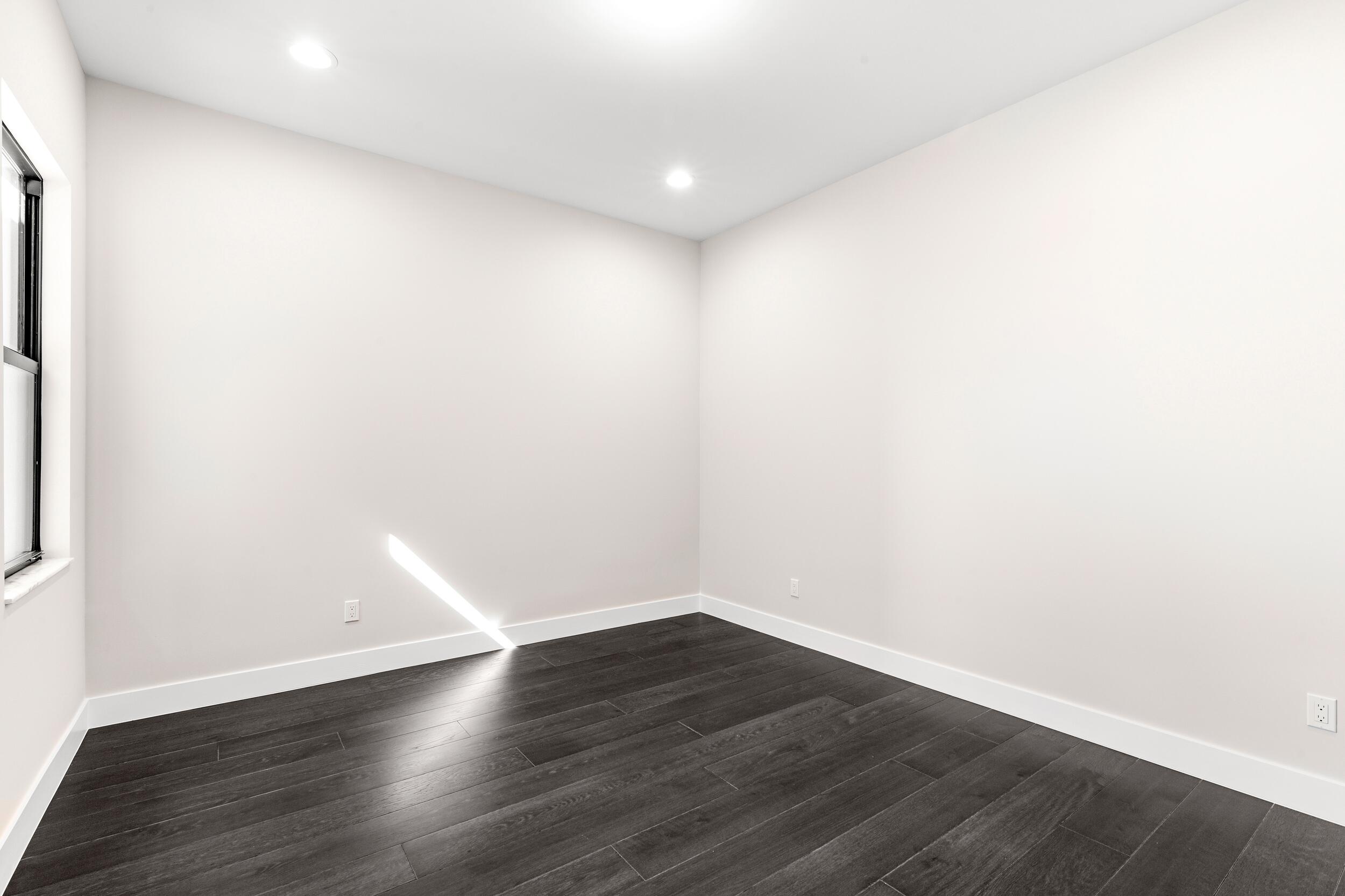 9132 Benedetta Place Boca Raton, FL 33496 - Photo 43 of 50 a view of an empty room with wooden floor