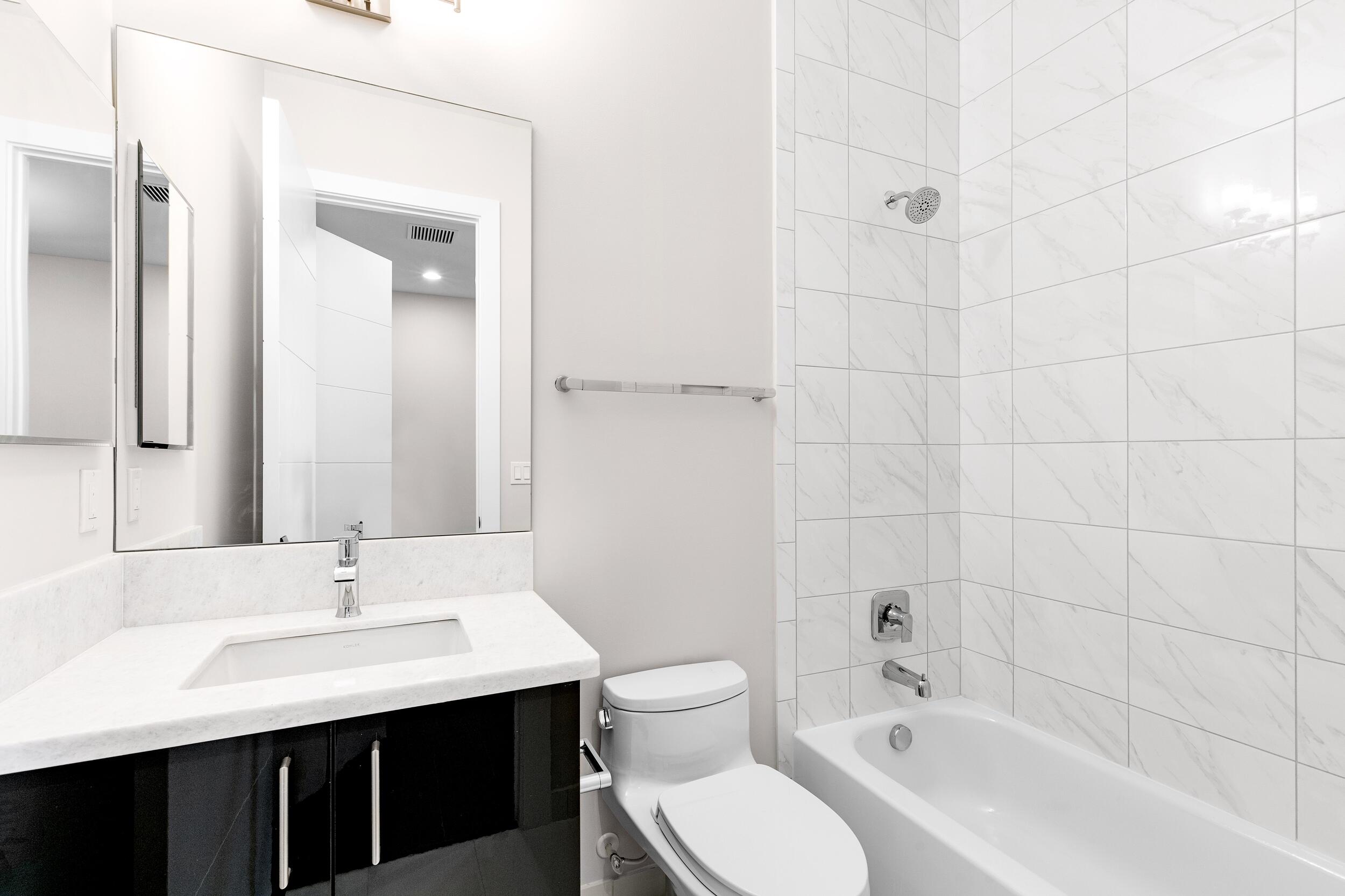 9132 Benedetta Place Boca Raton, FL 33496 - Photo 44 of 50 a bathroom with a sink toilet a shower and a mirror